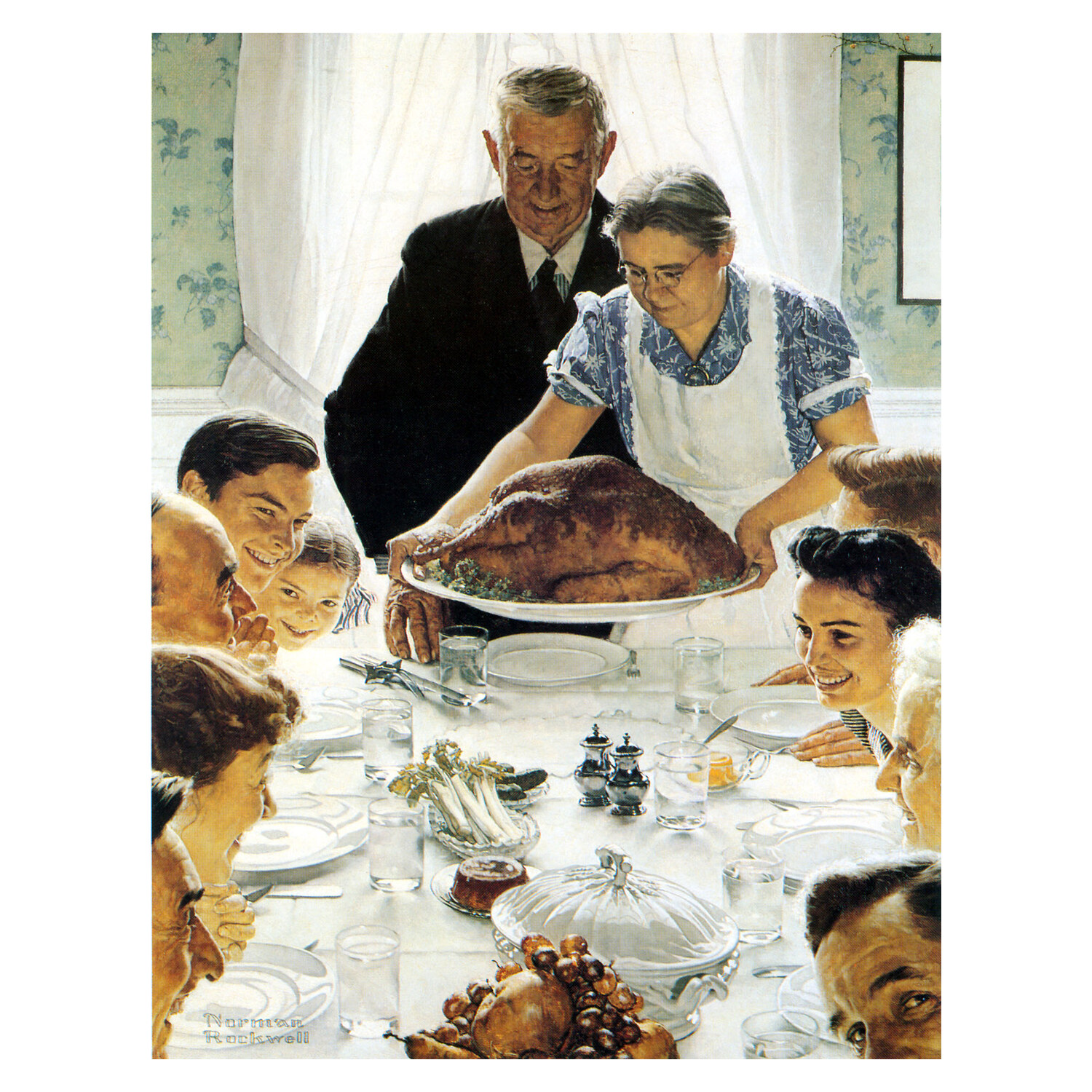 Family gathered at a table as a roast turkey is set down